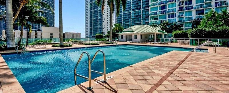 41 Southeast 5th Street, Unit 1517 Miami, FL 33131 - Photo 7 of 62 a view of swimming pool with outdoor seating and plants