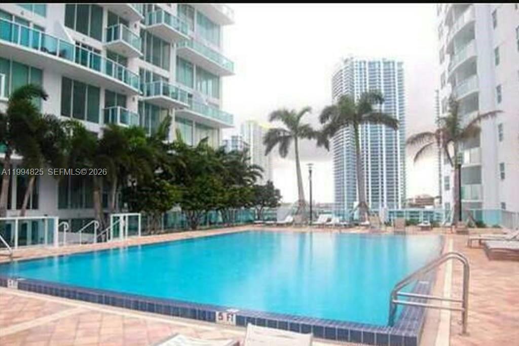 41 Southeast 5th Street, Unit 1517 Miami, FL 33131 - Photo 8 of 62 a view of a swimming pool with a yard