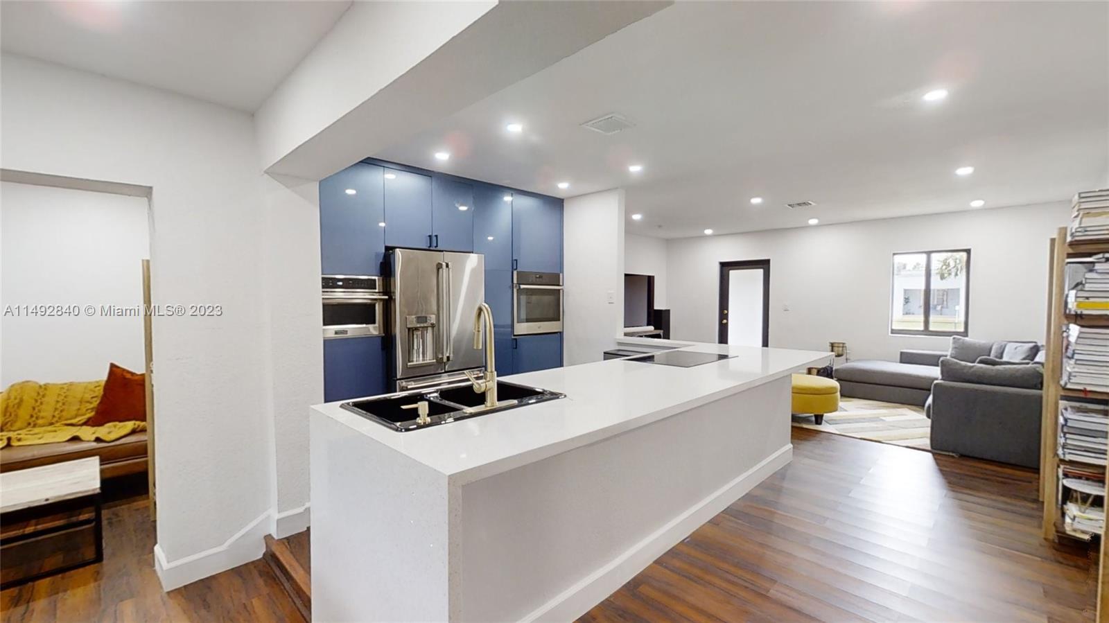 a large kitchen with a large counter top appliances and furniture