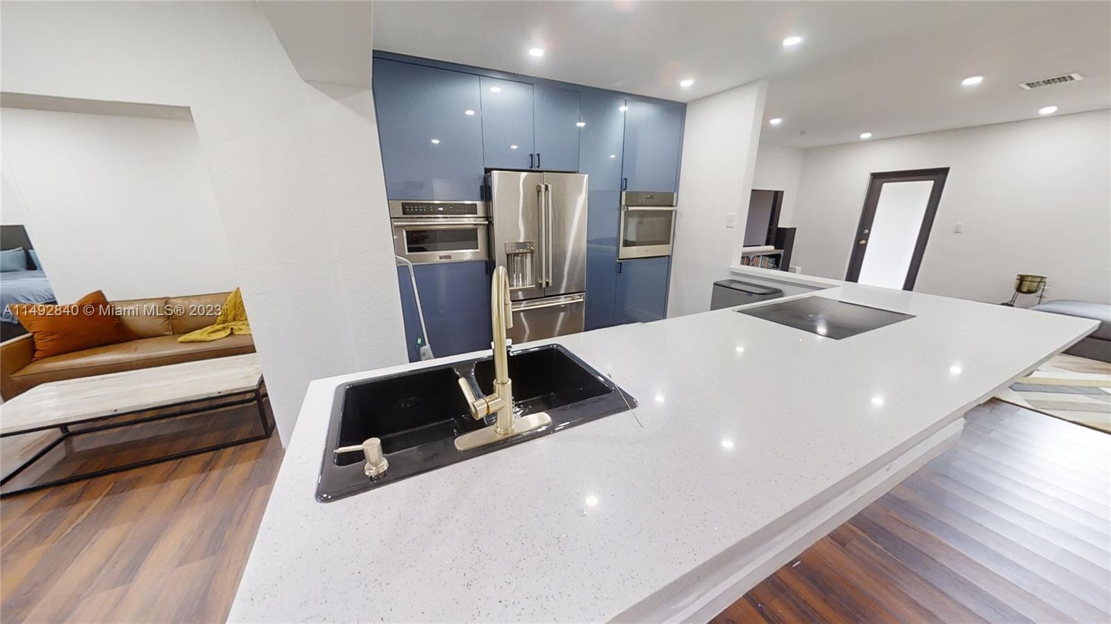 445 Southwest 62nd Court Miami, FL 33144 - Photo 11 of 49 a large kitchen with sink refrigerator and microwave