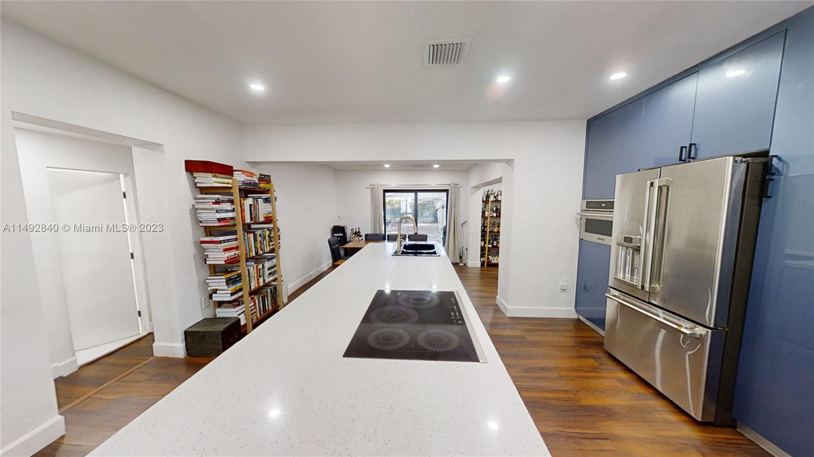 445 Southwest 62nd Court Miami, FL 33144 - Photo 12 of 49 a view of a kitchen with refrigerator and furniture