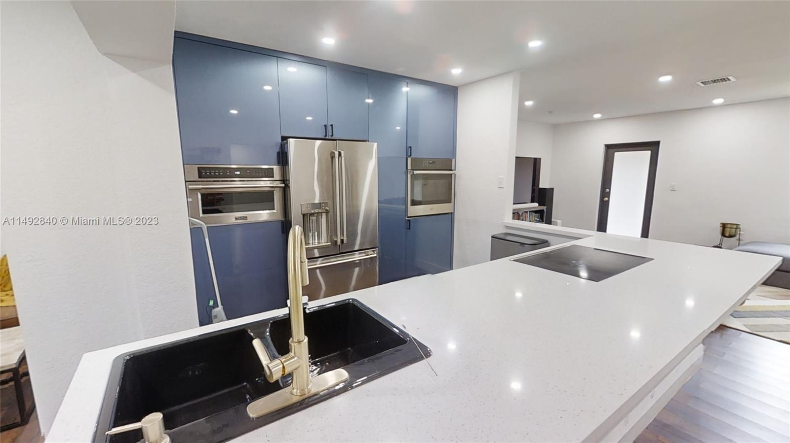 445 Southwest 62nd Court Miami, FL 33144 - Photo 13 of 49 a kitchen with stainless steel appliances a refrigerator and a sink