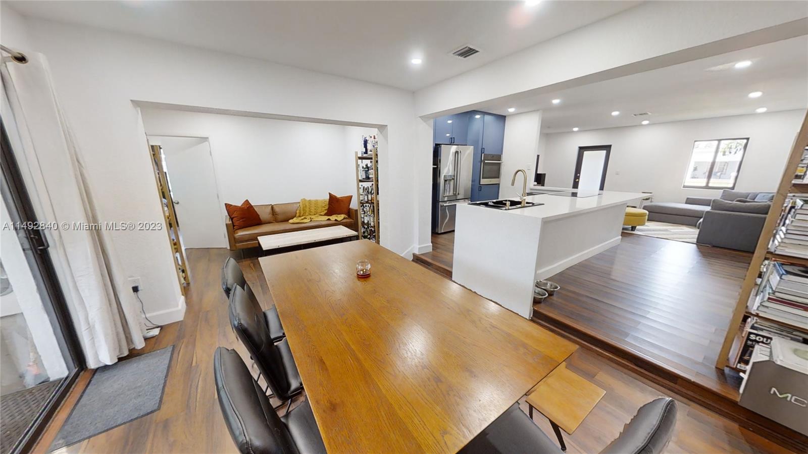 445 Southwest 62nd Court Miami, FL 33144 - Photo 15 of 49 a view of kitchen with stainless steel appliances refrigerator stove microwave and living room view