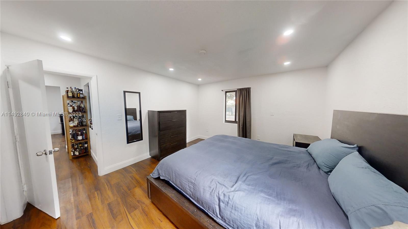 445 Southwest 62nd Court Miami, FL 33144 - Photo 18 of 49 a bed room with a bed and a television