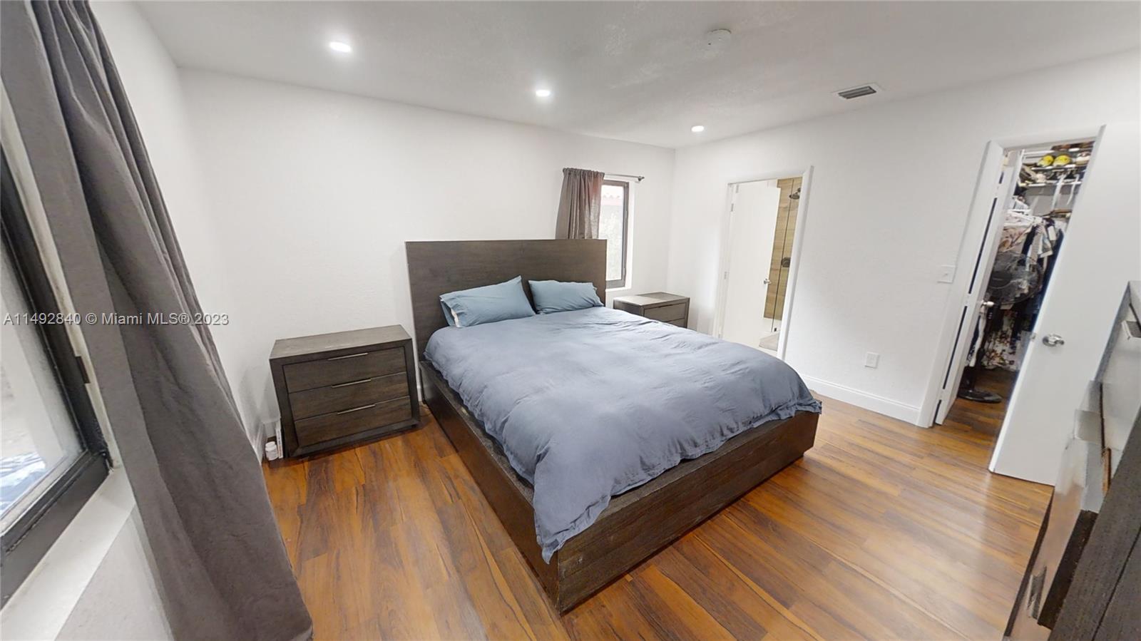 445 Southwest 62nd Court Miami, FL 33144 - Photo 21 of 49 a bedroom with a bed and a flat tv screen on a dresser