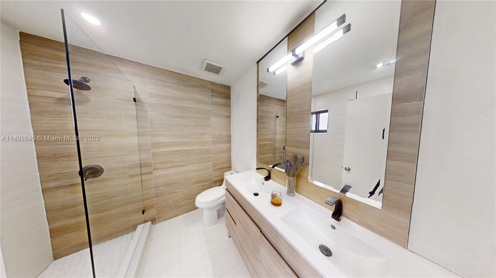 445 Southwest 62nd Court Miami, FL 33144 - Photo 23 of 49 a bathroom with a tub sink and mirror