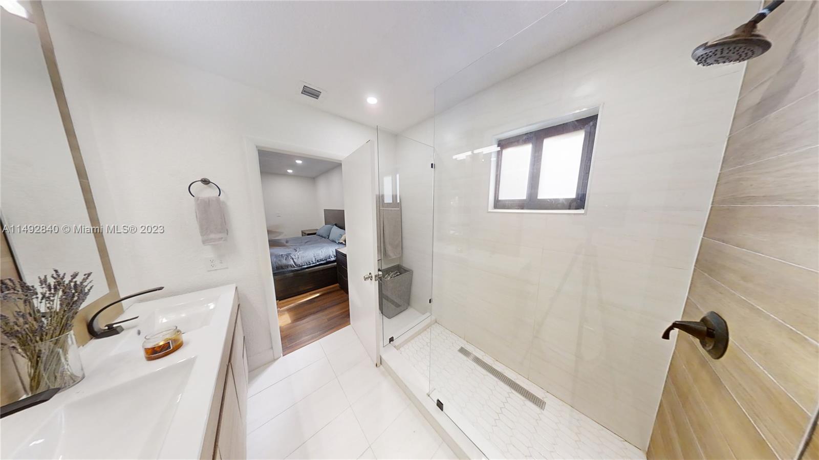 445 Southwest 62nd Court Miami, FL 33144 - Photo 25 of 49 a bathroom with a bathtub sink and mirror