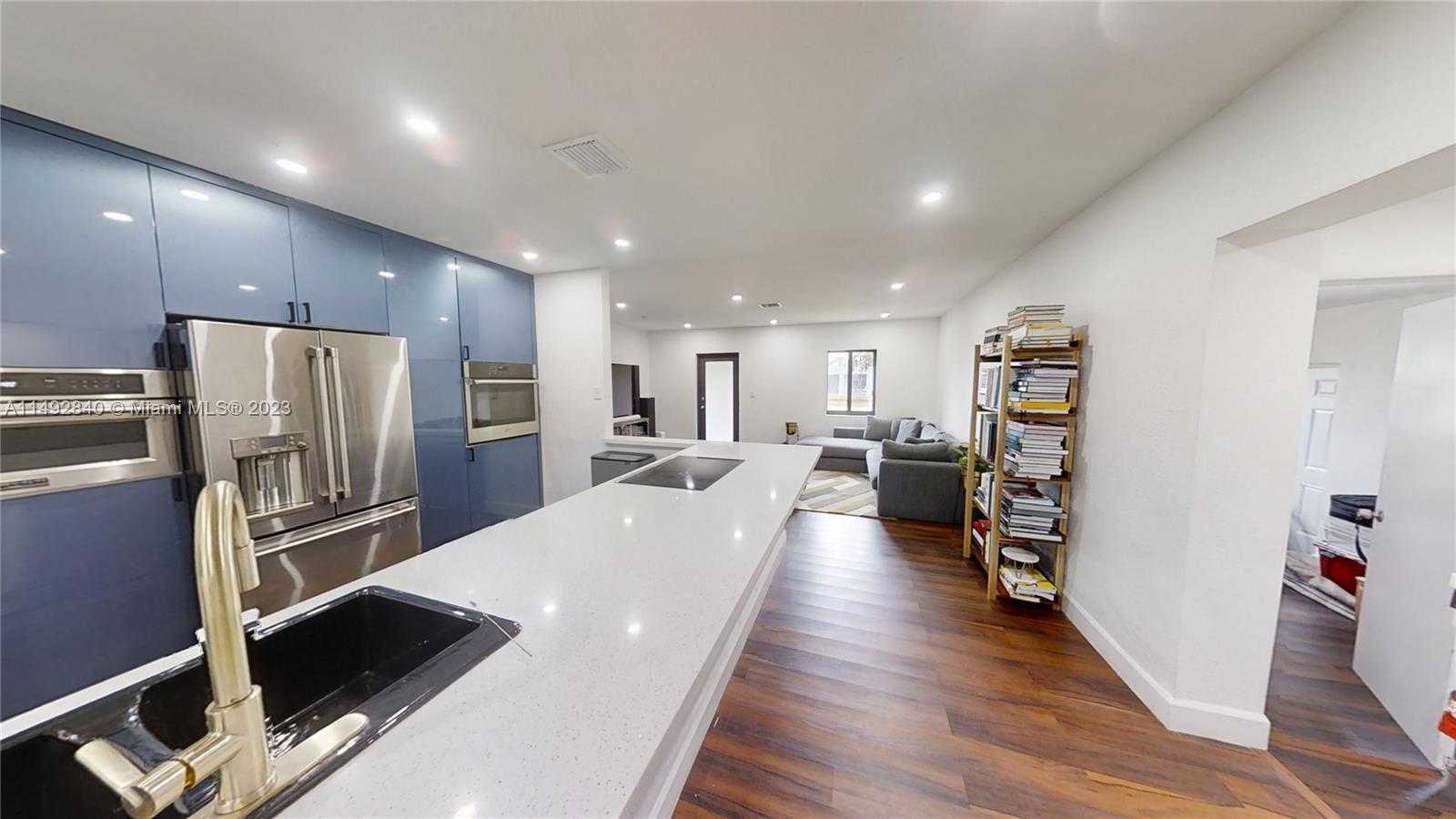 445 Southwest 62nd Court Miami, FL 33144 - Photo 28 of 49 a large room with kitchen view and a refrigerator