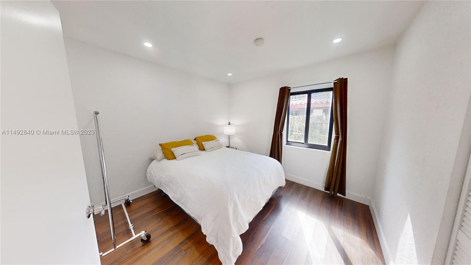 445 Southwest 62nd Court Miami, FL 33144 - Photo 30 of 49 a bedroom with a bed and wooden floor