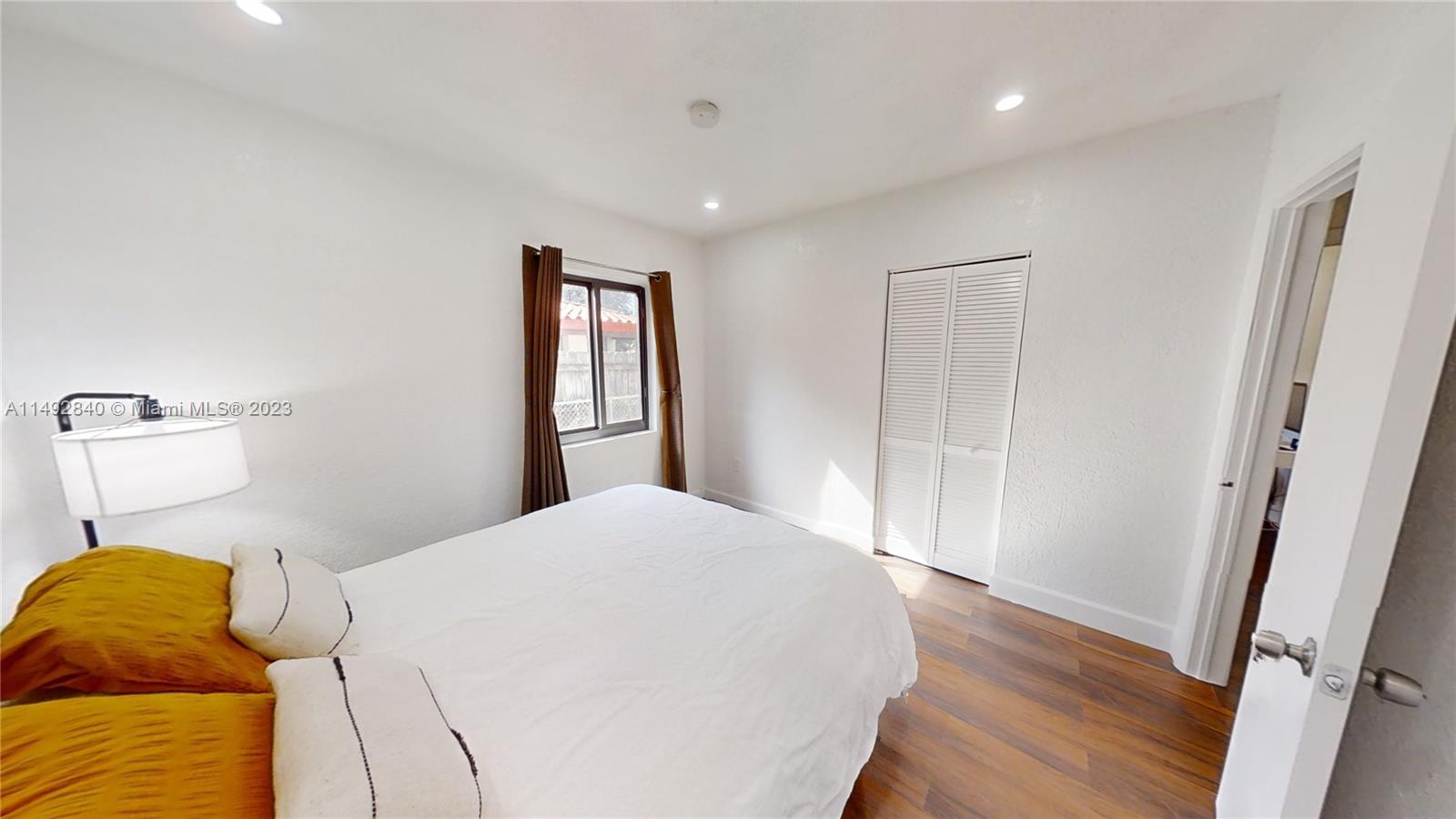 445 Southwest 62nd Court Miami, FL 33144 - Photo 32 of 49 a bedroom with a bed and wooden floor