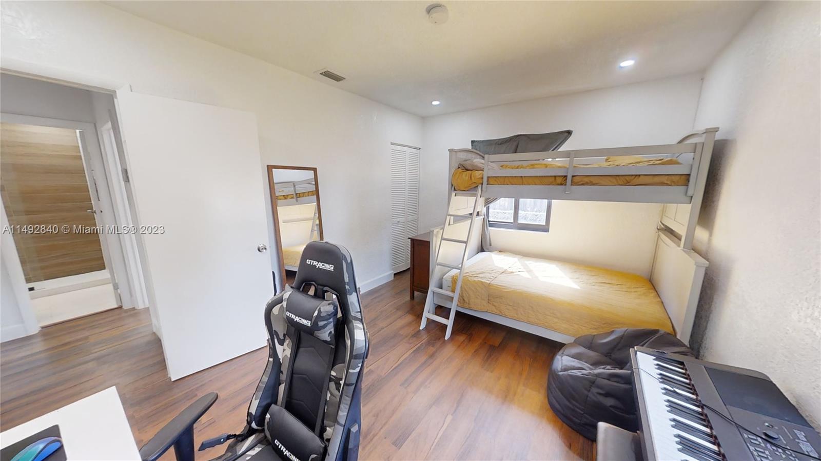 445 Southwest 62nd Court Miami, FL 33144 - Photo 38 of 49 a bedroom with two beds and wooden floor