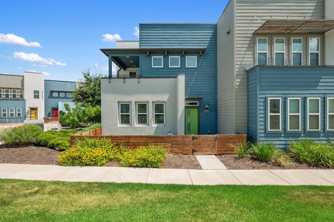 9015 Cattle Baron Path, Unit 2005 Austin, TX 78747 - Photo 1 of 37 a front view of a house with a yard