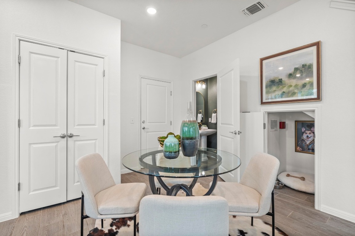 9015 Cattle Baron Path, Unit 2005 Austin, TX 78747 - Photo 11 of 37 a dining room with furniture and wooden floor