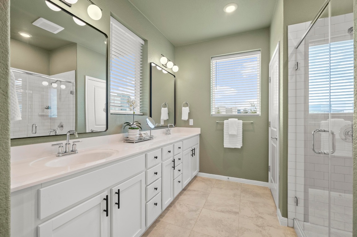 9015 Cattle Baron Path, Unit 2005 Austin, TX 78747 - Photo 15 of 37 a bathroom with double sink and a mirror