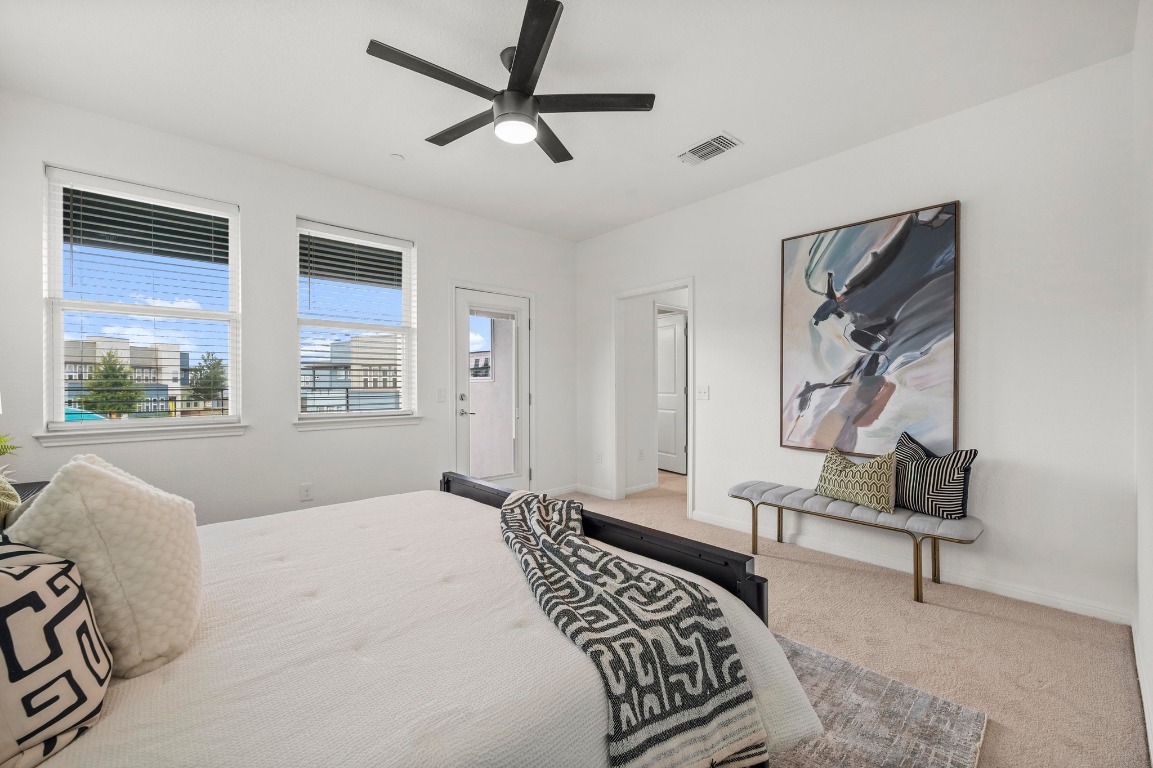 9015 Cattle Baron Path, Unit 2005 Austin, TX 78747 - Photo 18 of 37 a bedroom with a bed dresser and a window