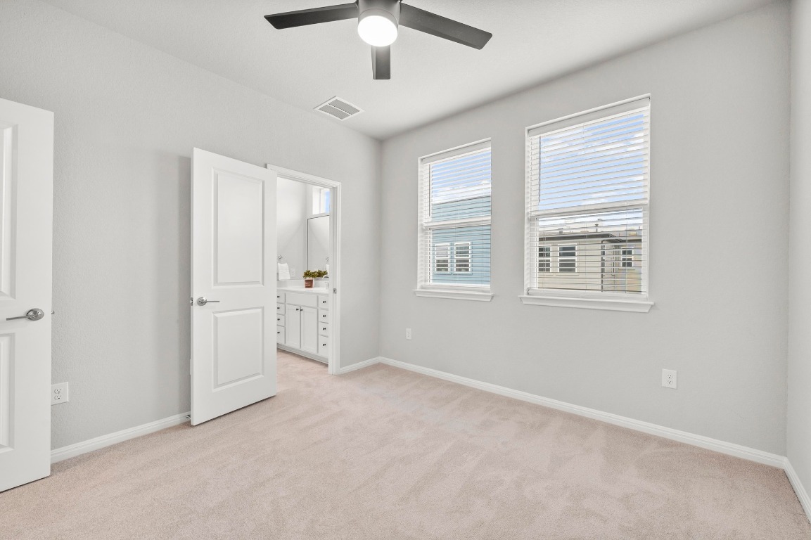 9015 Cattle Baron Path, Unit 2005 Austin, TX 78747 - Photo 23 of 37 an empty room with windows and ceiling fan