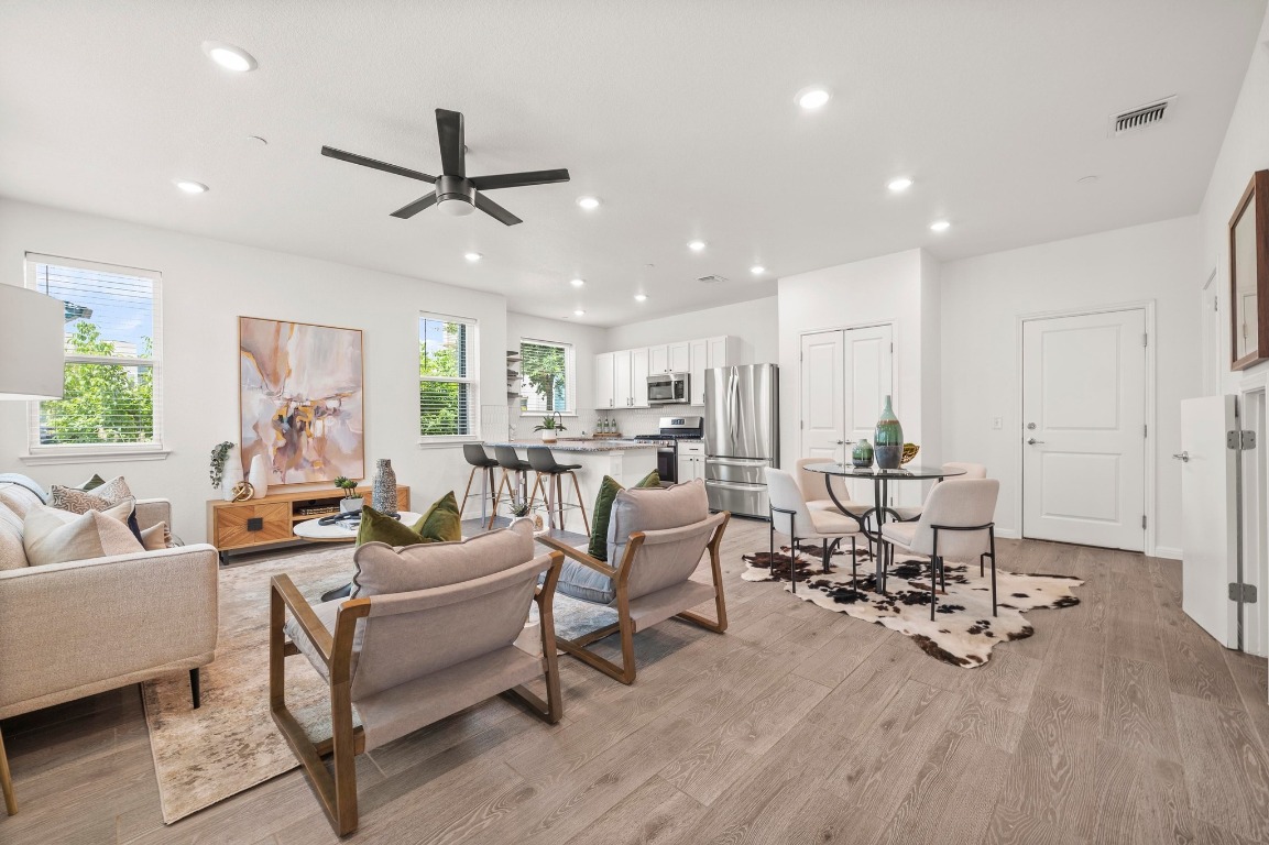 9015 Cattle Baron Path, Unit 2005 Austin, TX 78747 - Photo 3 of 37 a living room with furniture and a wooden floor