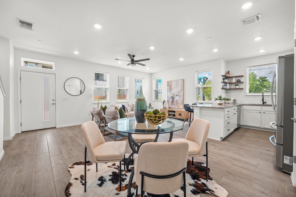 9015 Cattle Baron Path, Unit 2005 Austin, TX 78747 - Photo 5 of 37 a very nice looking open dining room with kitchen island stainless steel appliances a table and chairs