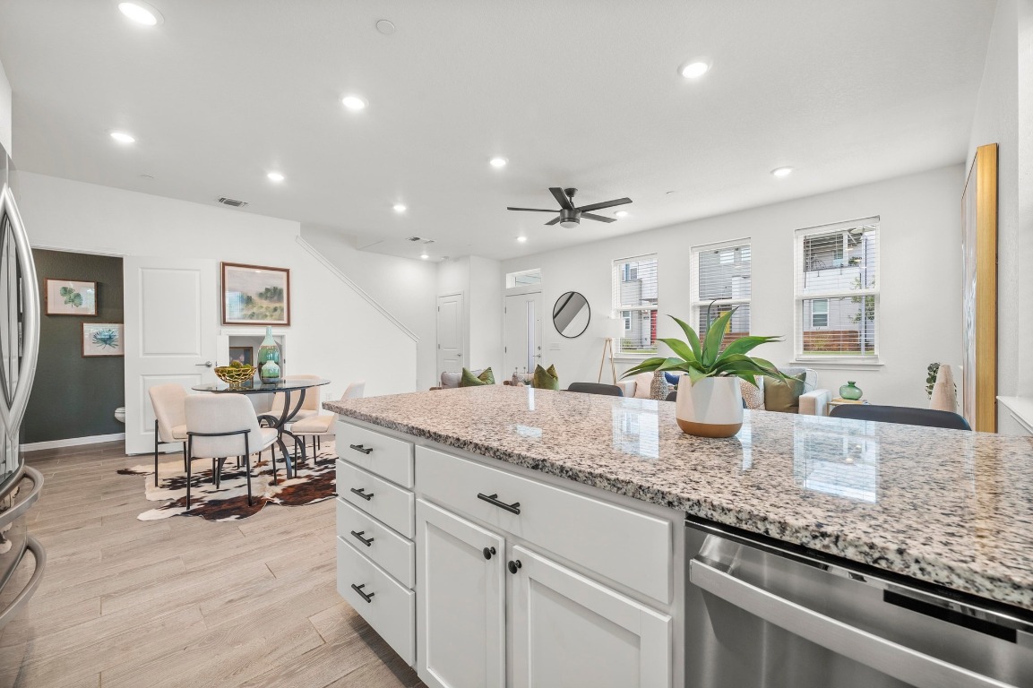 9015 Cattle Baron Path, Unit 2005 Austin, TX 78747 - Photo 10 of 37 a kitchen with granite countertop white cabinets and chairs
