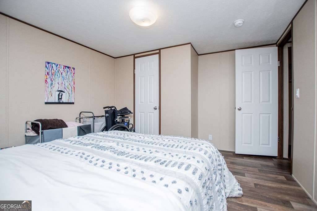 450 Glenloch Road Roopville, GA 30170 - Photo 25 of 38 a large bedroom with a bed and a table in it