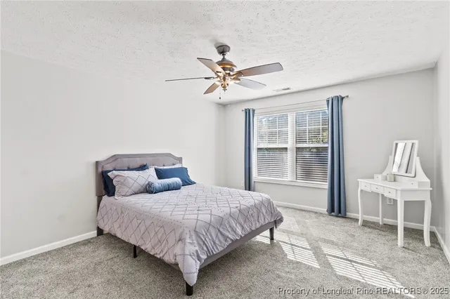 a bedroom with a bed chandelier and a window