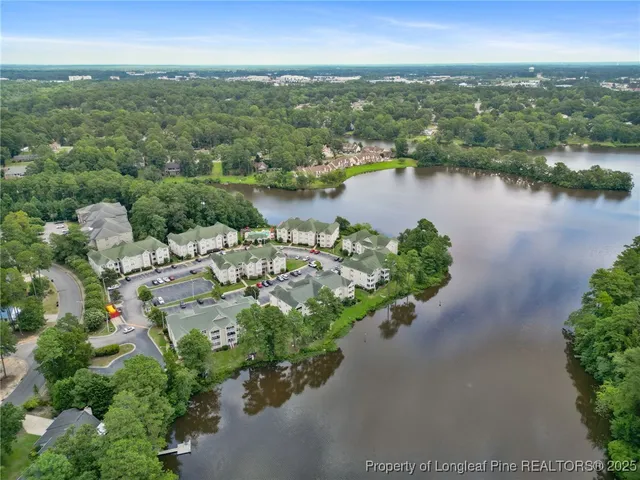 an aerial view of a houses with a lake view