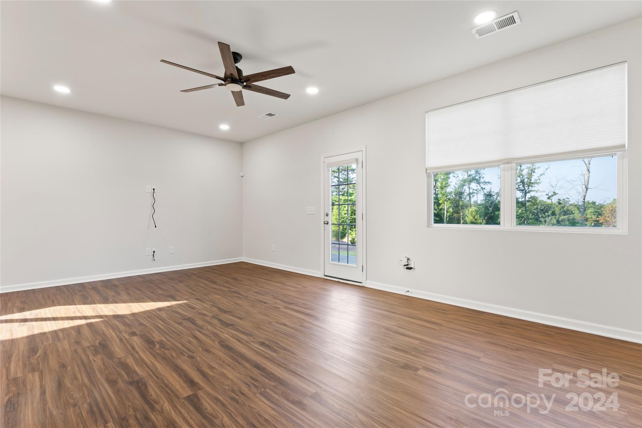 1655 Corwin Bend Road Tega Cay, SC 29708 - Photo 12 of 41 a view of an empty room with wooden floor and a window
