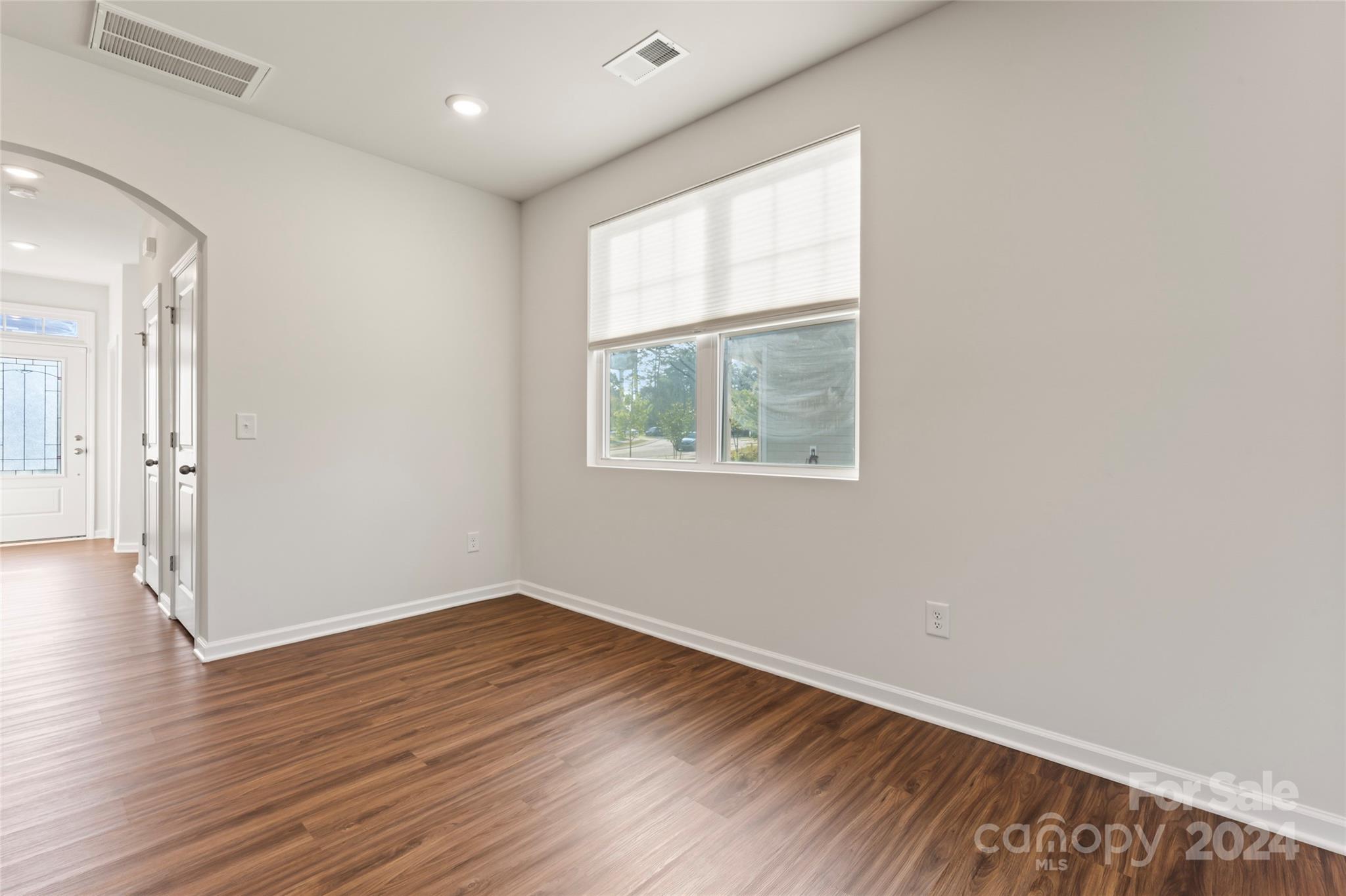 1655 Corwin Bend Road Tega Cay, SC 29708 - Photo 16 of 41 a view of an empty room with wooden floor and a window