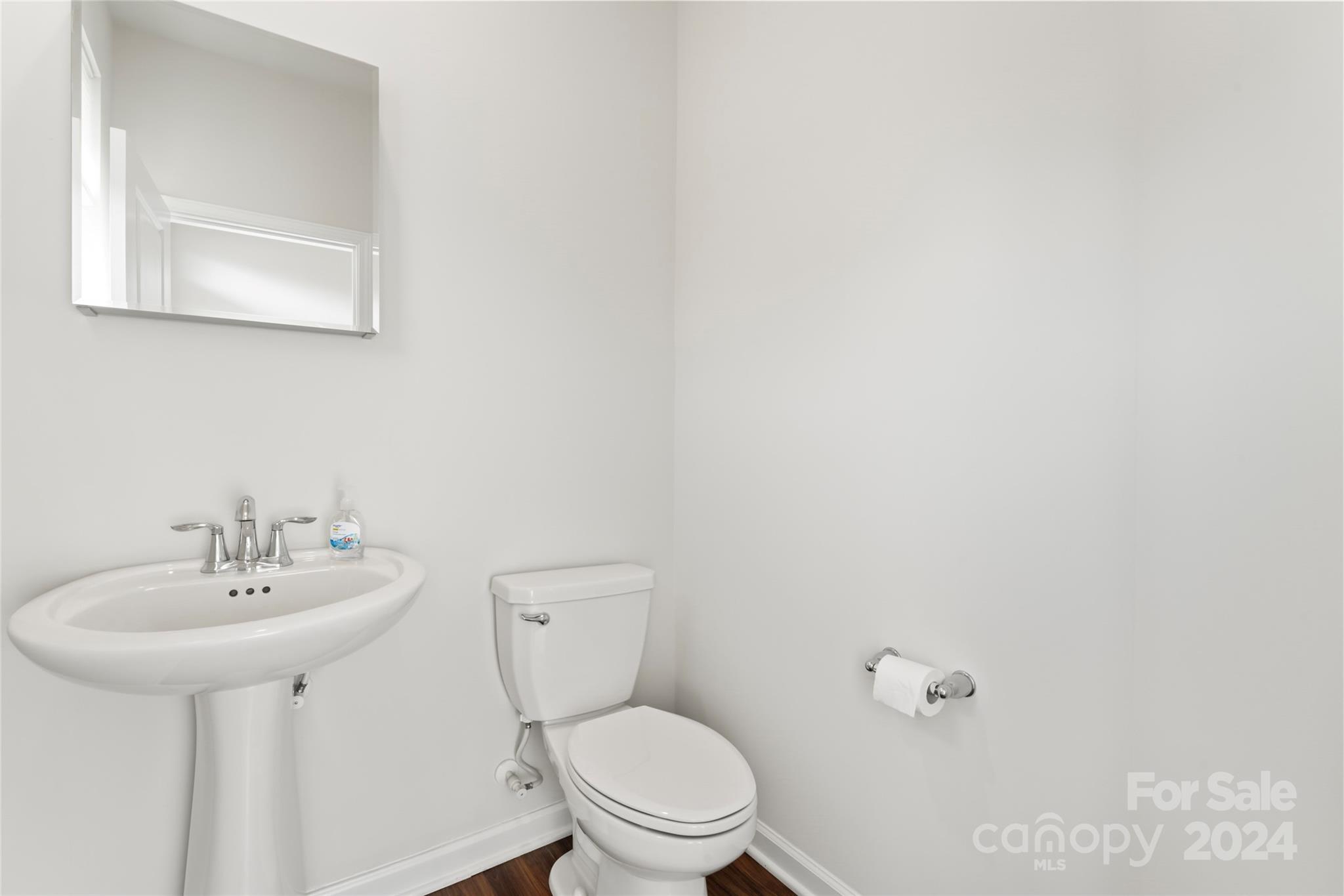 1655 Corwin Bend Road Tega Cay, SC 29708 - Photo 21 of 41 a bathroom with a toilet sink and mirror