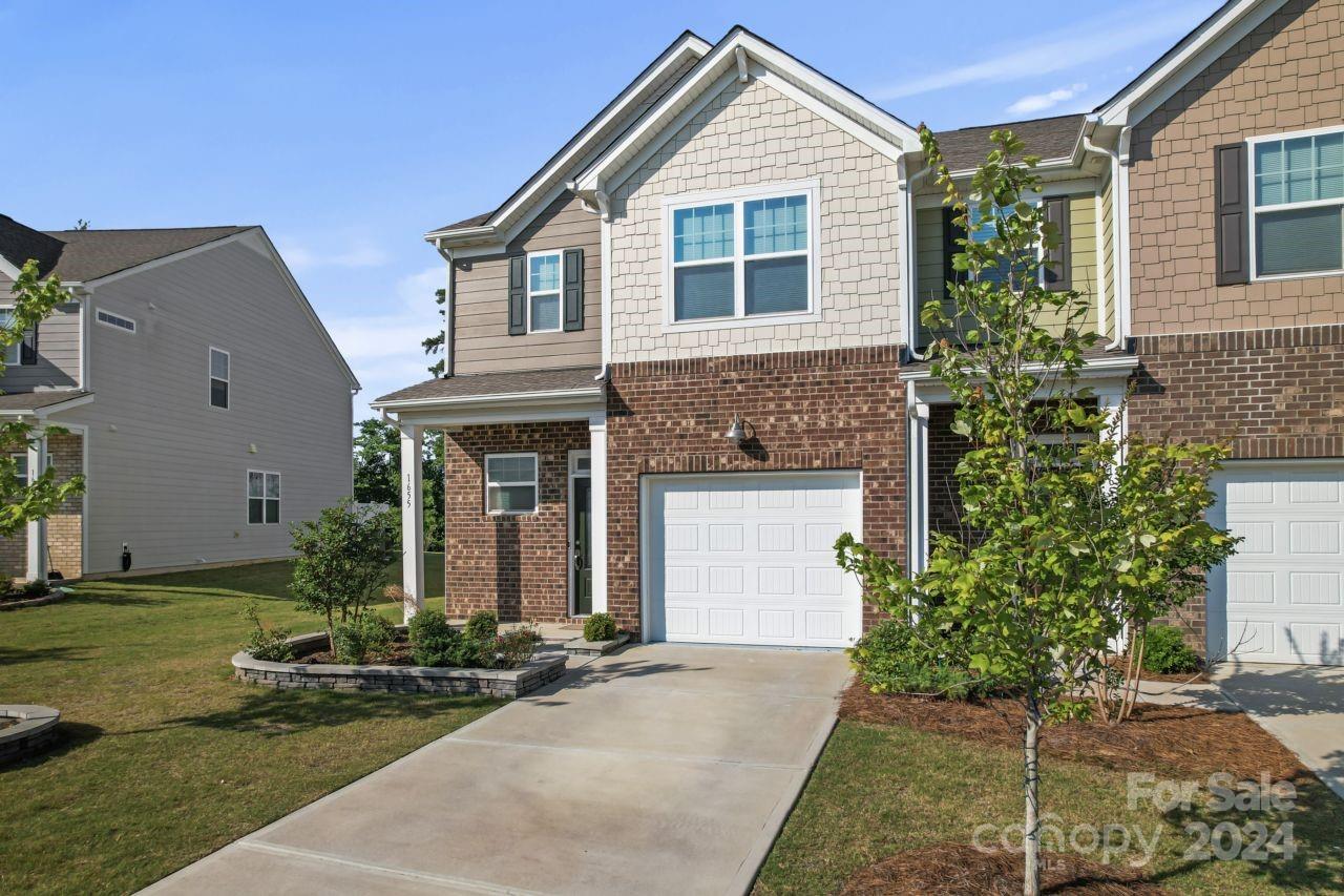 1655 Corwin Bend Road Tega Cay, SC 29708 - Photo 3 of 41 a front view of a house with garden