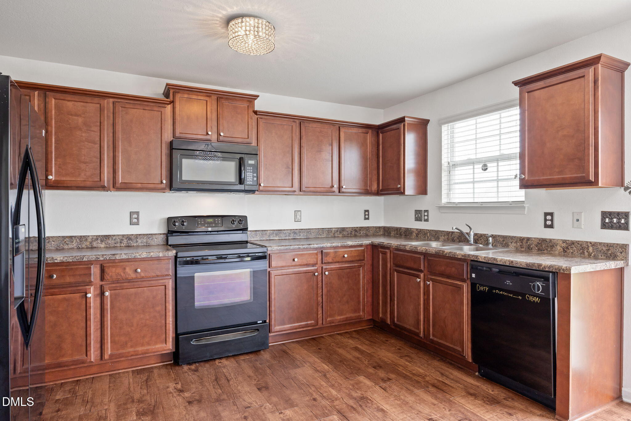 239 Battery Way Bunnlevel, NC 28323 - Photo 12 of 47 a kitchen with stainless steel appliances granite countertop a stove sink microwave and window