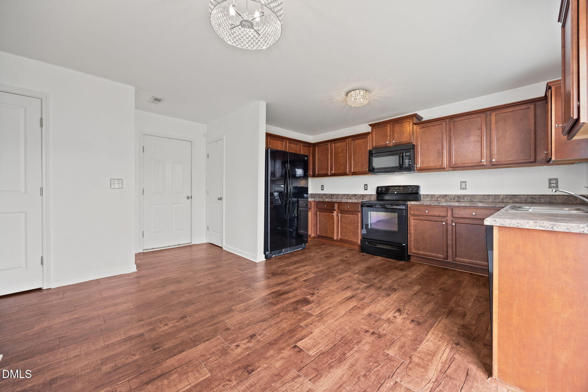 239 Battery Way Bunnlevel, NC 28323 - Photo 14 of 47 a kitchen with stainless steel appliances granite countertop a stove top oven a sink dishwasher and a refrigerator with wooden floor