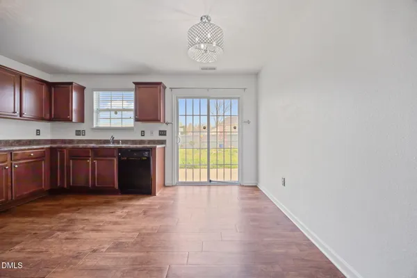 a large kitchen with stainless steel appliances granite countertop a stove a sink dishwasher and a refrigerator