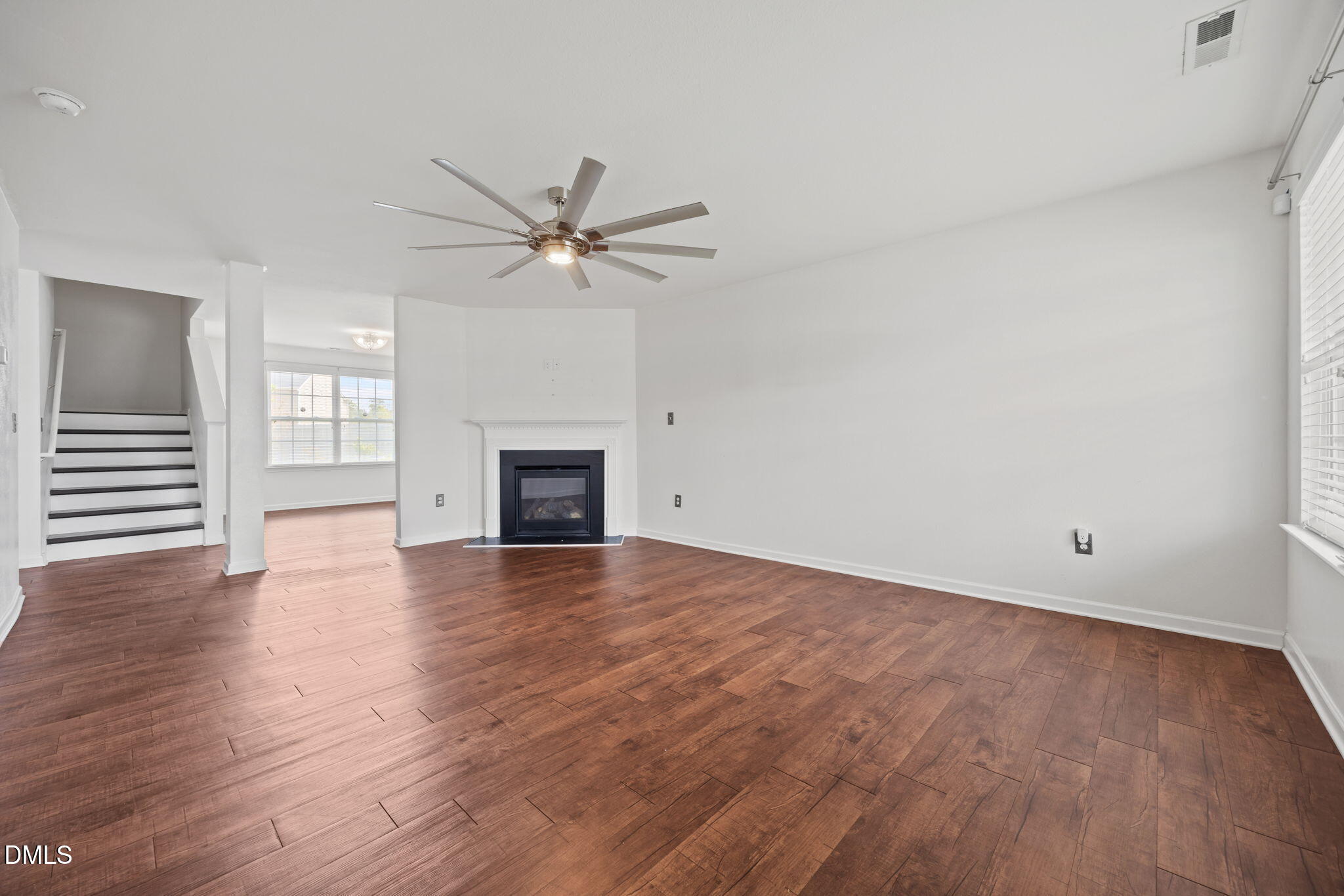 239 Battery Way Bunnlevel, NC 28323 - Photo 20 of 47 an empty room with wooden floor and fireplace