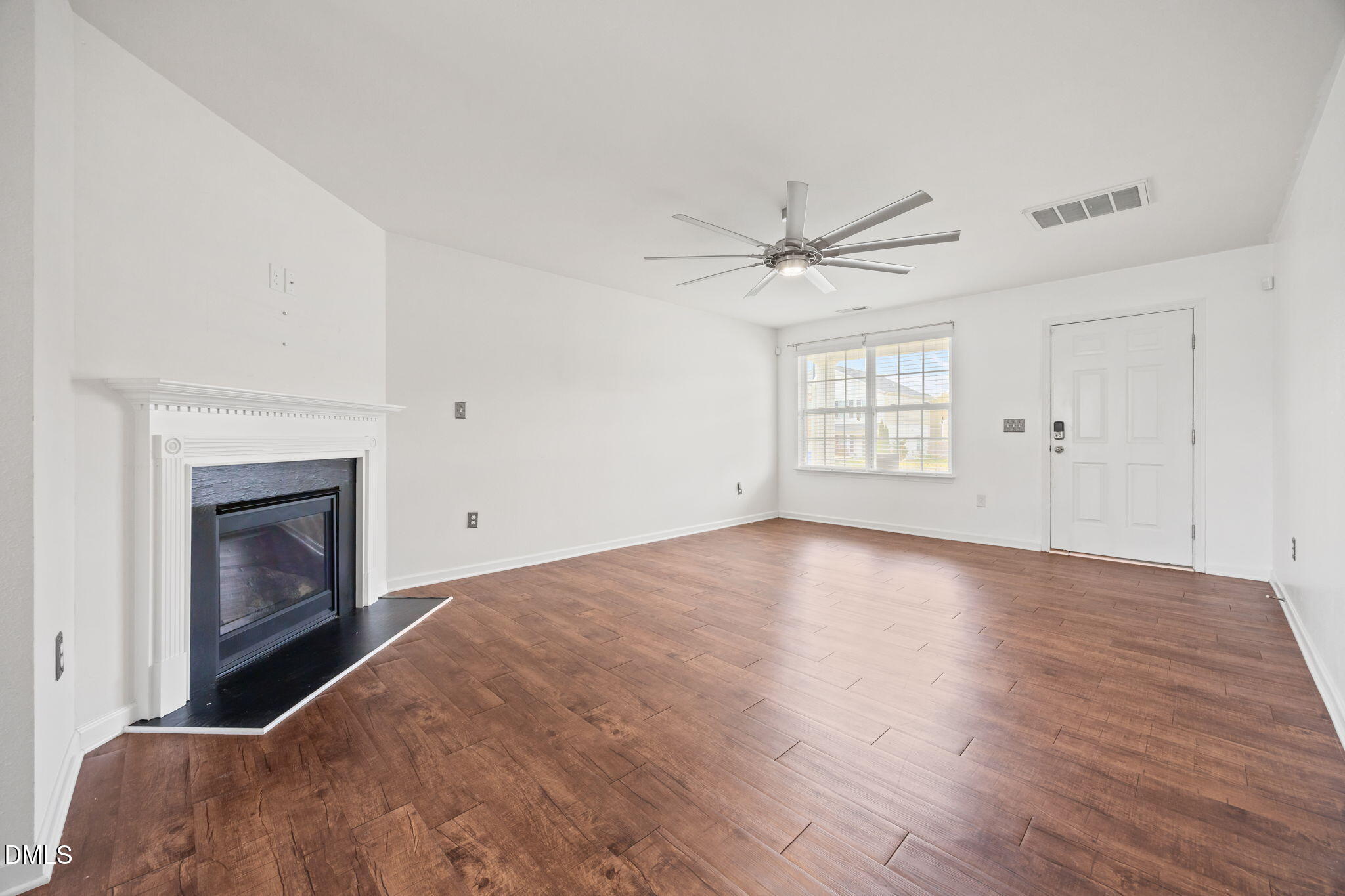 239 Battery Way Bunnlevel, NC 28323 - Photo 21 of 47 a view of empty room with wooden floor and fireplace