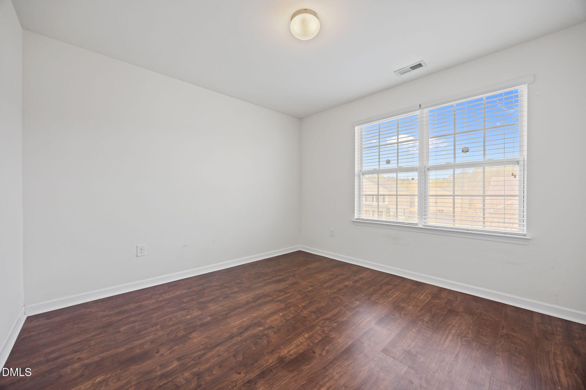 239 Battery Way Bunnlevel, NC 28323 - Photo 36 of 47 an empty room with wooden floor and windows