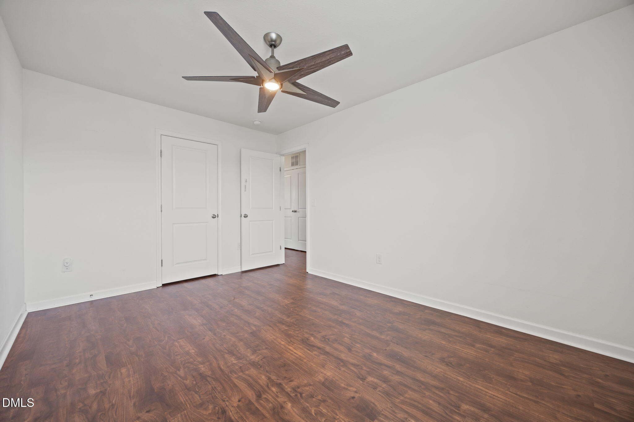 239 Battery Way Bunnlevel, NC 28323 - Photo 38 of 47 an empty room with wooden floor fan and windows