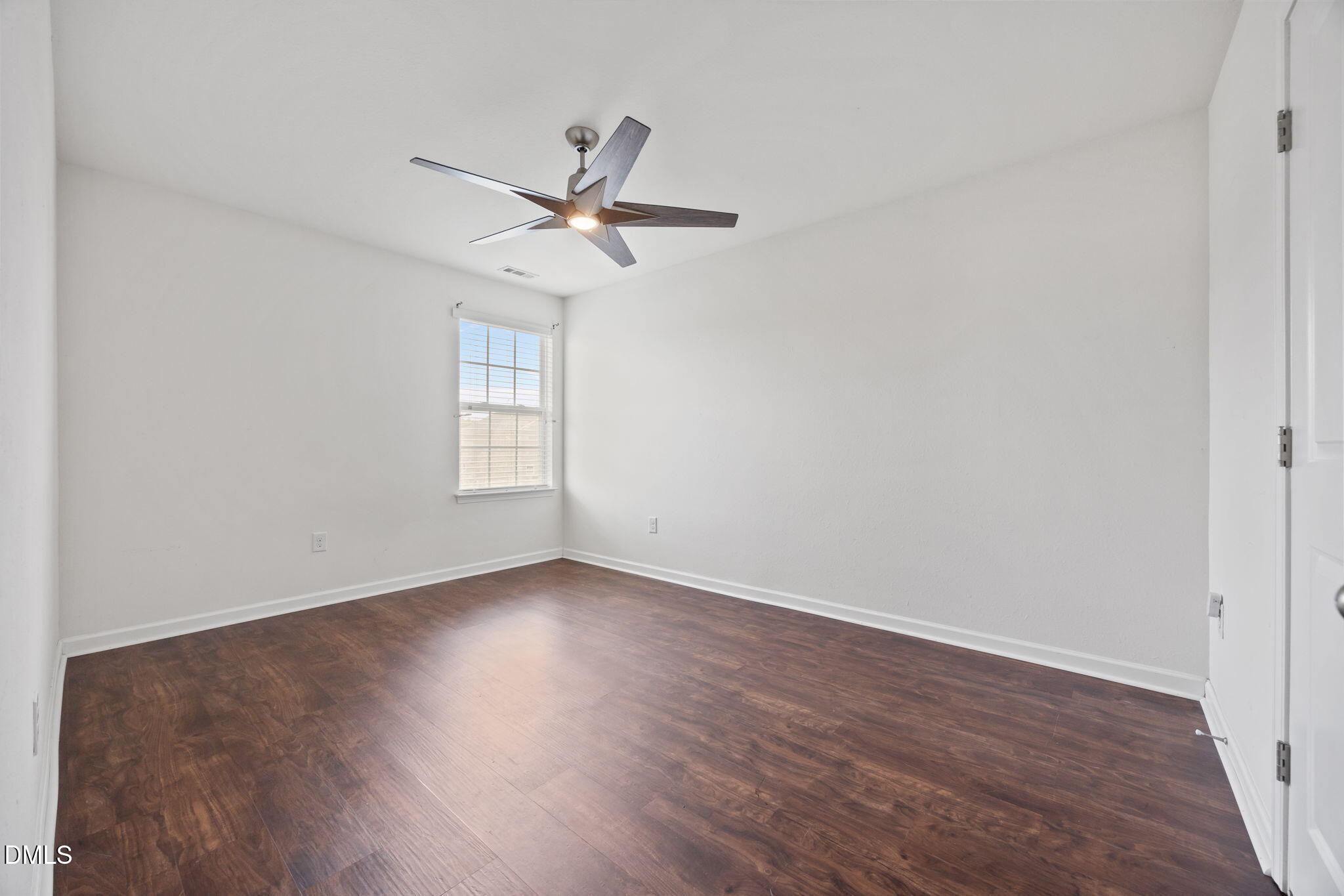 239 Battery Way Bunnlevel, NC 28323 - Photo 39 of 47 an empty room with wooden floor fan and windows