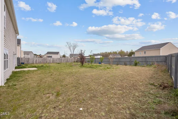 a view of a big yard with large trees