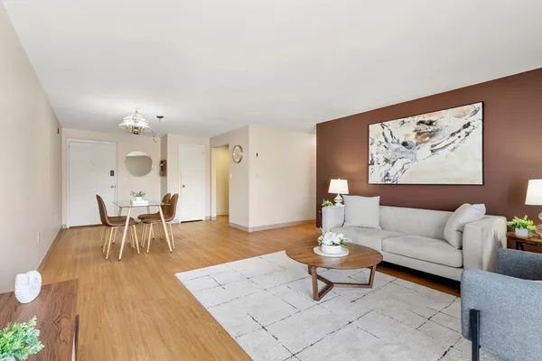 a bedroom with a bed rug and wooden floor