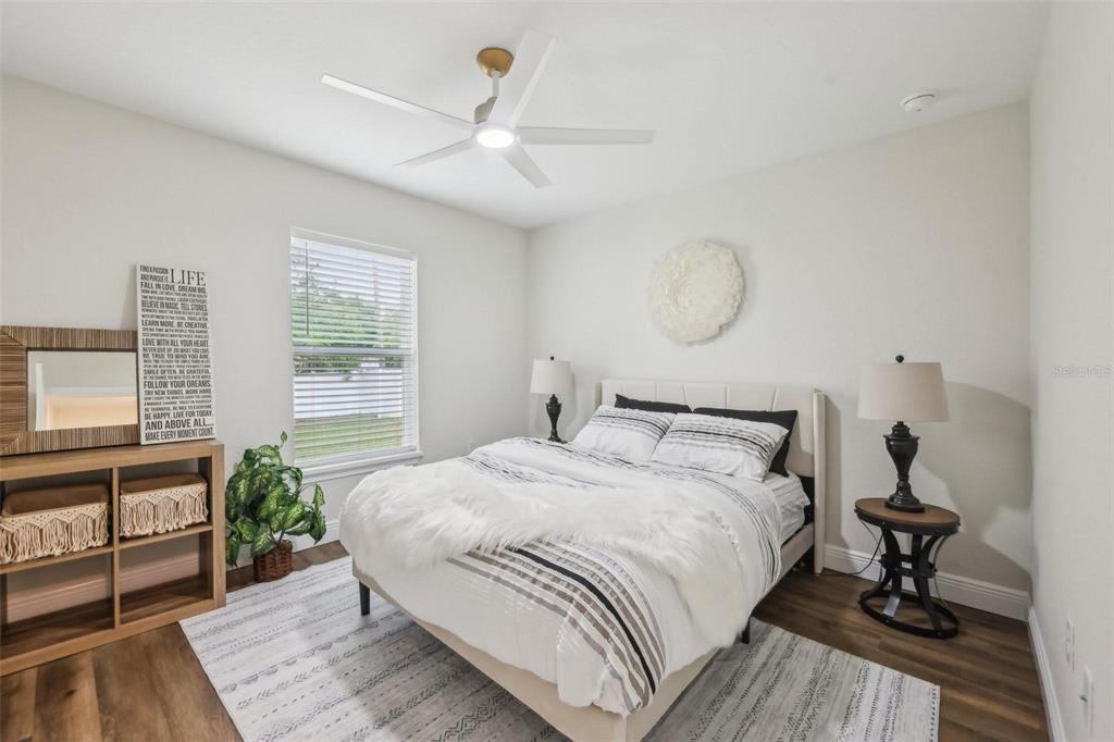 7217 Hemlock Loop Ocala, FL 34472 - Photo 16 of 27 a bedroom with a bed and windows