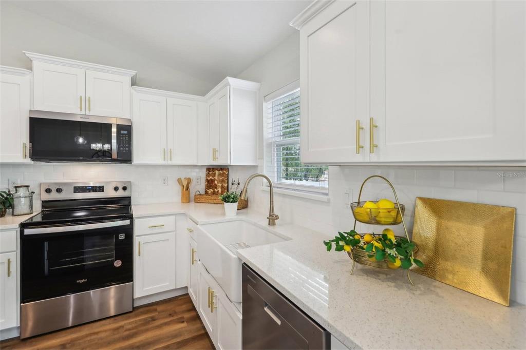 7217 Hemlock Loop Ocala, FL 34472 - Photo 17 of 36 a kitchen with a sink a stove and cabinets