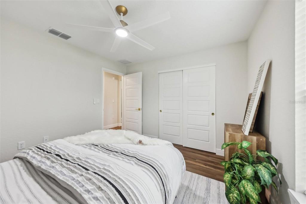 7217 Hemlock Loop Ocala, FL 34472 - Photo 17 of 27 a bedroom with a bed and a potted plant