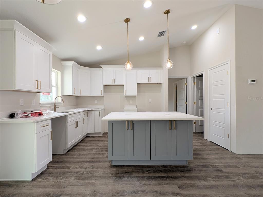 7217 Hemlock Loop Ocala, FL 34472 - Photo 2 of 36 a kitchen with kitchen island a sink stainless steel appliances and cabinets