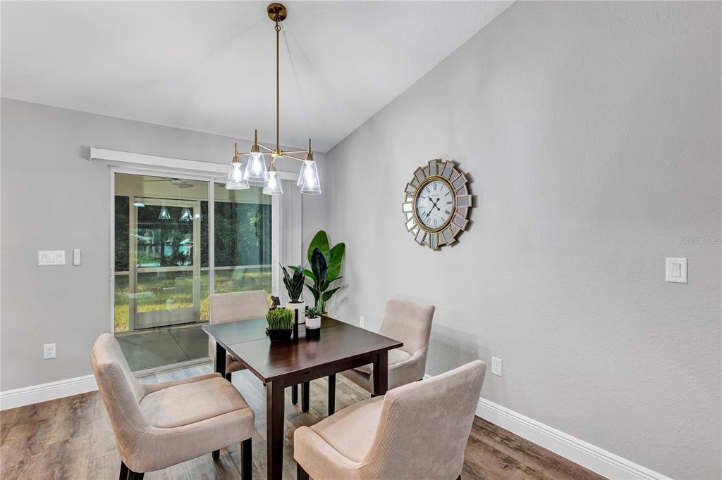 7217 Hemlock Loop Ocala, FL 34472 - Photo 25 of 27 a dining room with furniture a chandelier and window