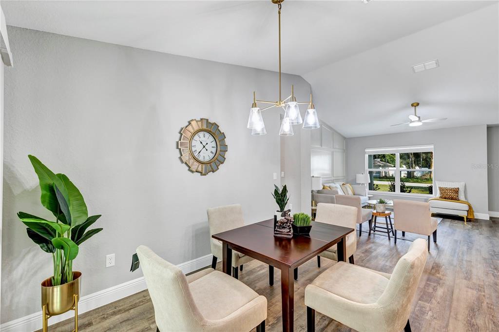 7217 Hemlock Loop Ocala, FL 34472 - Photo 36 of 36 a view of a dining room with furniture a chandelier and wooden floor