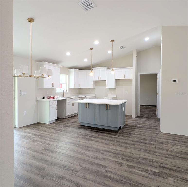 7217 Hemlock Loop Ocala, FL 34472 - Photo 4 of 36 a large kitchen with a lot of counter space and stainless steel appliances