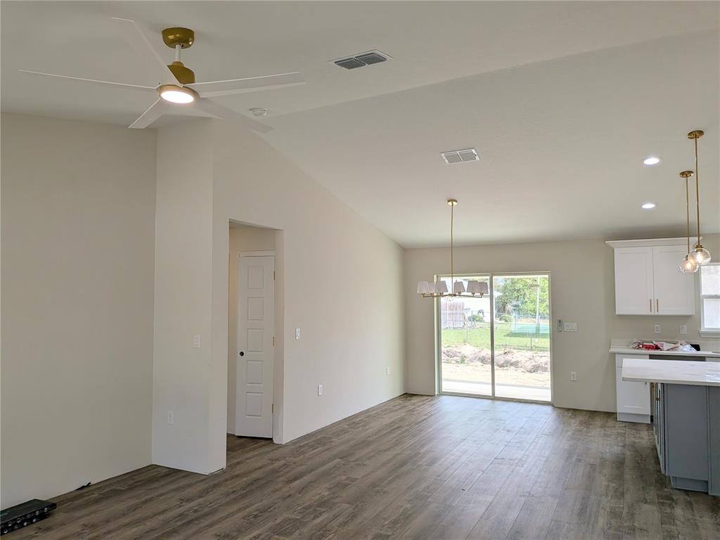 7217 Hemlock Loop Ocala, FL 34472 - Photo 5 of 36 a view of an empty room with window and wooden floor