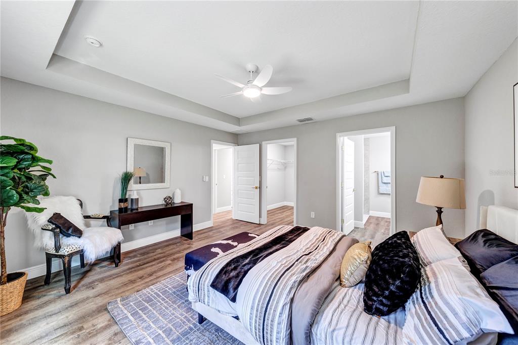 7217 Hemlock Loop Ocala, FL 34472 - Photo 10 of 27 a bedroom with a bed lamp closet and large window