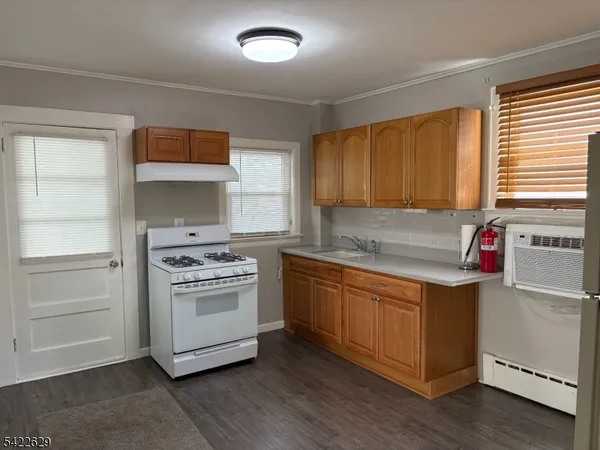 a kitchen with stainless steel appliances granite countertop a sink a stove and a refrigerator